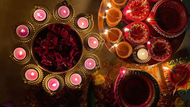 6. Use diyas and lamps to illuminate your space: Lighting is a crucial element in creating a divine atmosphere during Durga Pooja. Use ghee or mustard oil to light the diyas as they are considered pure and effective in spreading positive energy. Make sure the diyas are placed on clean surfaces and avoid dark or cluttered corners. (Image source: Pinterest/shikhachaurasiaaa)