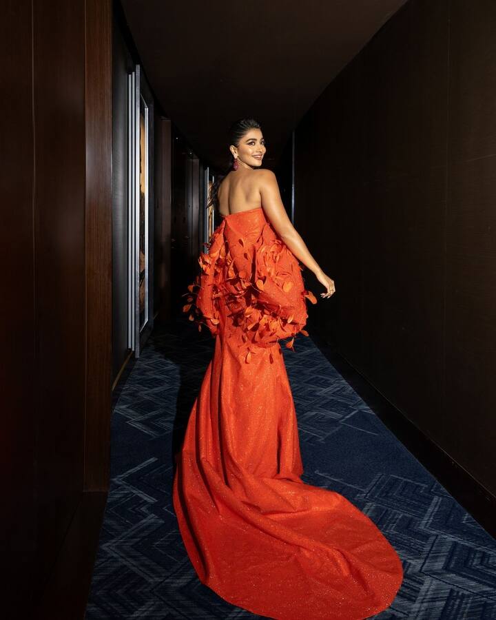 Pooja’s hair was styled to perfection with a sleek, wet-look finish, left loose at the back to complement the gown.