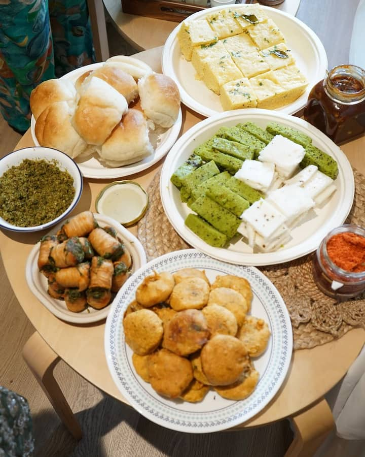 A highlight of the festive spread is a tempting glimpse of the 'special bhog,' featuring vada pav, dhokla, and chutney, adding a delicious touch.