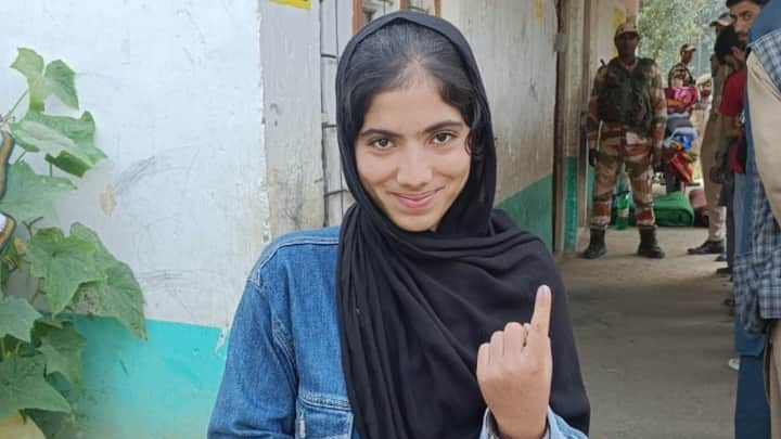 A young voter shows off her inked finger after casting her vote at a polling station in Jammu & Kashmir. (Photo:@ceo_UTJK)