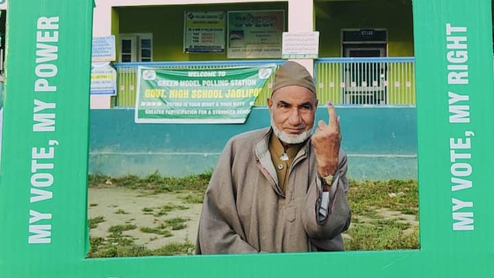 An elderly man poses at a polling booth's photo corner. Polling for the second and third phases of the assembly elections will be held on September 25 and October 1, respectively. (Photo: @DCAnantnag)