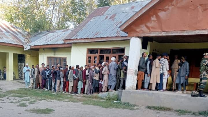 Voters at a polling booth in Dooru, Anantnag, early in the morning. The voting is underway with extensive security arrangements. (Photo: @ECISVEEP)