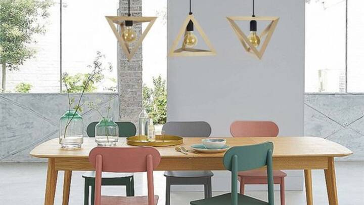 4. Decor And Lighting: Soft, warm lighting in the dining area creates a cozy and inviting atmosphere. Natural light during the day is highly beneficial, but in the evening, ensure the space is well-lit to foster positive energy. Earthy tones, such as light yellow, cream, or pastel shades, on the walls are ideal as they radiate warmth and tranquility. Avoid harsh or overly bright colors, which can create agitation or tension. (Image Source: Pinterest/WayfairUK)
