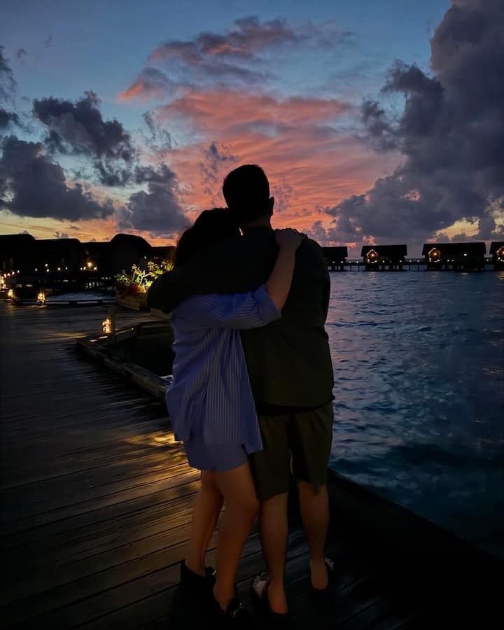 Parineeti posted a photo to Instagram of herself and Raghav Chadha sipping drinks while sitting on chairs near the beach and gazing out to sea.
