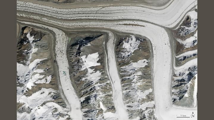 MADE BY NATURE: On August 14, 2015, the glaciers of the Tian Shan mountains in northeastern Kyrgyzstan were photographed by the Operational Land Imager (OLI) on Landsat 8. The dark brown line running through the glacier is a medial moraine, where sediment collects as glaciers merge. Photo: NASA
