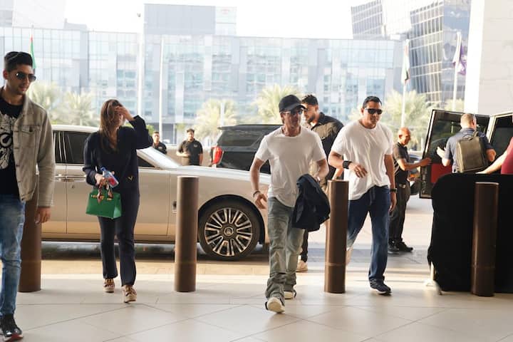 Shahrukh Khan completed his look with black glasses and a black hat. He is also carrying a jacket in his hand.