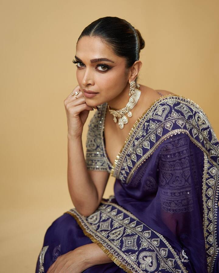 In a stunning purple saree, Deepika Padukone flaunted her baby bump and radiant pregnancy glow. The Bollywood star paired her look with elegant gold jewelry and styled her hair in a sleek bun.