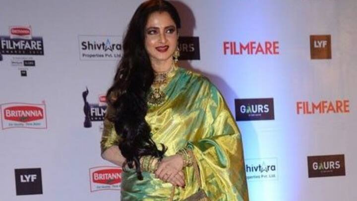 6. Green Elegant Saree: Rekha looks stunning in a traditional green silk saree, accessorised with gold jewelry. Her voluminous hair and elegant pose complete her timeless, graceful appearance. (Image Source: Pinterest/Sunshine_0827)