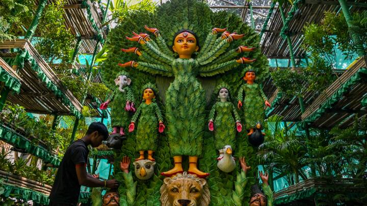 An artist prepares an 'environment-friendly' puja pandal using plants for Durga Puja, at Lalabagan Nabankur in Kolkata. (Photo: PTI)