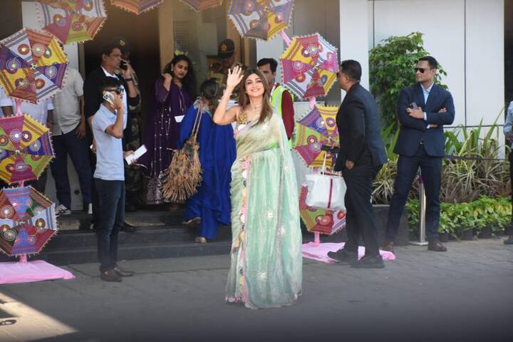 She looked beautiful in a green saree as she waved to the paparazzi.