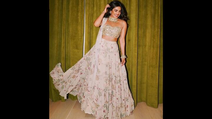 4. Priyanka Chopra: This beautiful floral lehenga oozes elegance with its pastel colours and flowing fabric. Priyanka Chopra has beautifully paired it with a gold sequin blouse and a statement neck piece that adds glamour to her outfit. (Image Source: Twitter/@prixkuttyiruu)