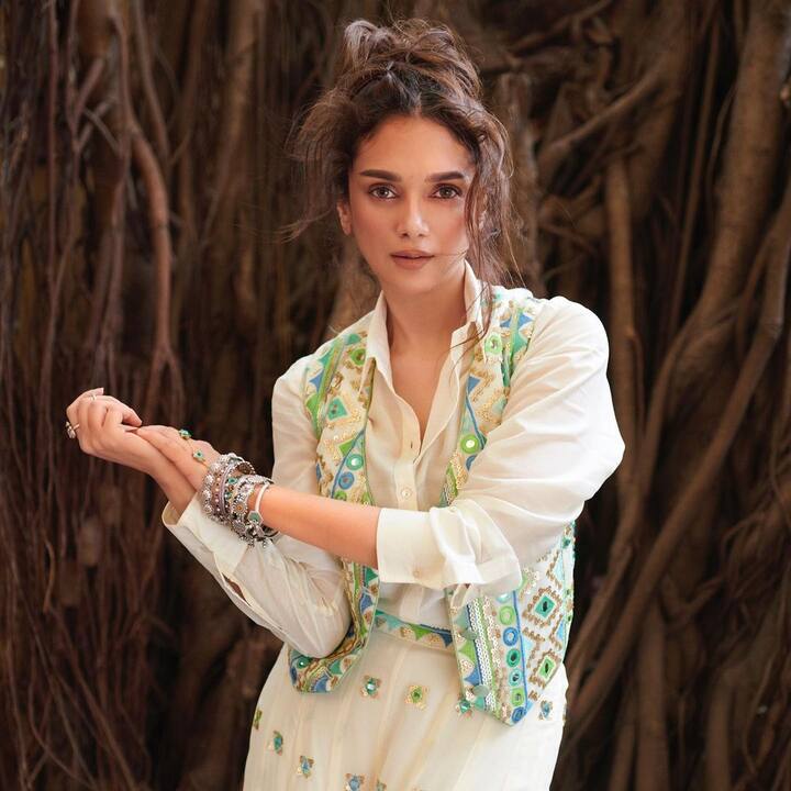 This white outfit features intricate traditional embroidery paired with a stylish waitscoat, creating an elegant look. The eye-catching Boho bracelet adds a quirky touch, perfectly complementing her ensemble.