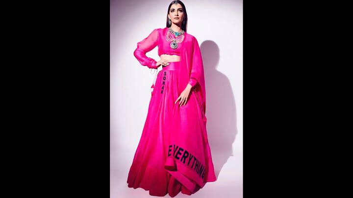 3. Sonam Kapoor: The bold letters on the hem of this vibrant hot pink lehenga gives a unique touch to the outfit. Sonam Kapoor has paired it with a flowy blouse, dupatta and statement jewellery pieces for a chic and modern look. (Image Source: Twitter/@SonamKapoorFC)