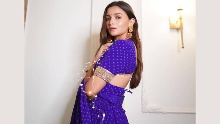 Blue Bandhani Lehenga: Alia's blue bandhani lehenga strikes a perfect balance between simplicity and grace. The broad golden border adds elegance, while the stylish blouse enhances the overall appeal. This look is especially fitting for dandiya and garba nights, embodying the essence of festive spirit. (Image source: Instagram/ aliaabhatt)
