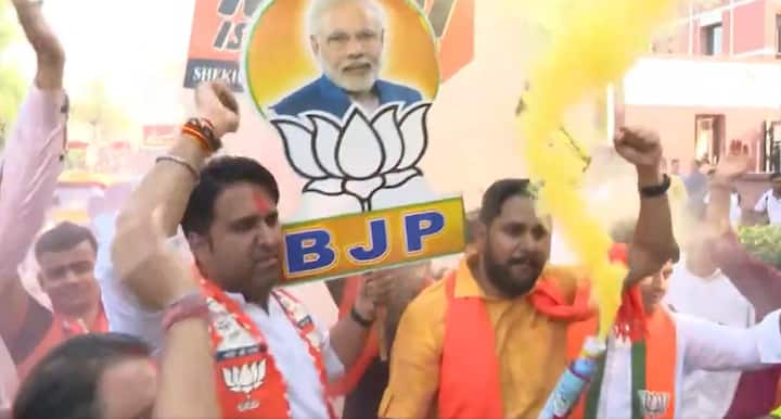 BJP supporters celebrate outside party headquarters in Delhi after victory in Haryana Assembly polls. (Image Source: PTI)