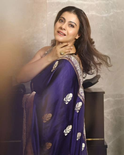 If you want to look trendy and glamorous this Durga Puja, you can recreate Kajol's blue saree look. Kajol looks absolutely beautiful in a saree with silver border.