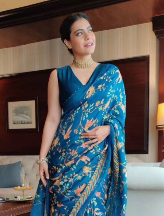 This look of Kajol is the best to look stylish on Durga Puja. When you wear this printed saree with a V neckline blouse, believe me, all eyes will be on you.