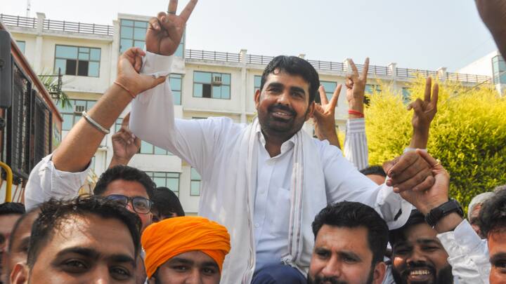BJP candidate Pawan Kharkhoda celebrates with supporters after his victory from Kharkhauda constituency in Sonipat district. He won by over 5,600 votes. (Photo: PTI)