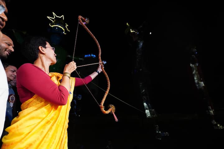 Delhi CM Atishi holds a bow and arrow during the celebration of the Dussehra organised by East Delhi's famous Ramleela Committee Indraprastha. (Source: X/@AtishiAAP)