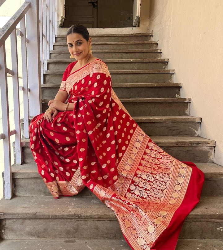 The actress draped a vibrant red-colored Kanjeevaram saree featuring intricate with golden work. She kept it with subtle nude makeup and a bun.