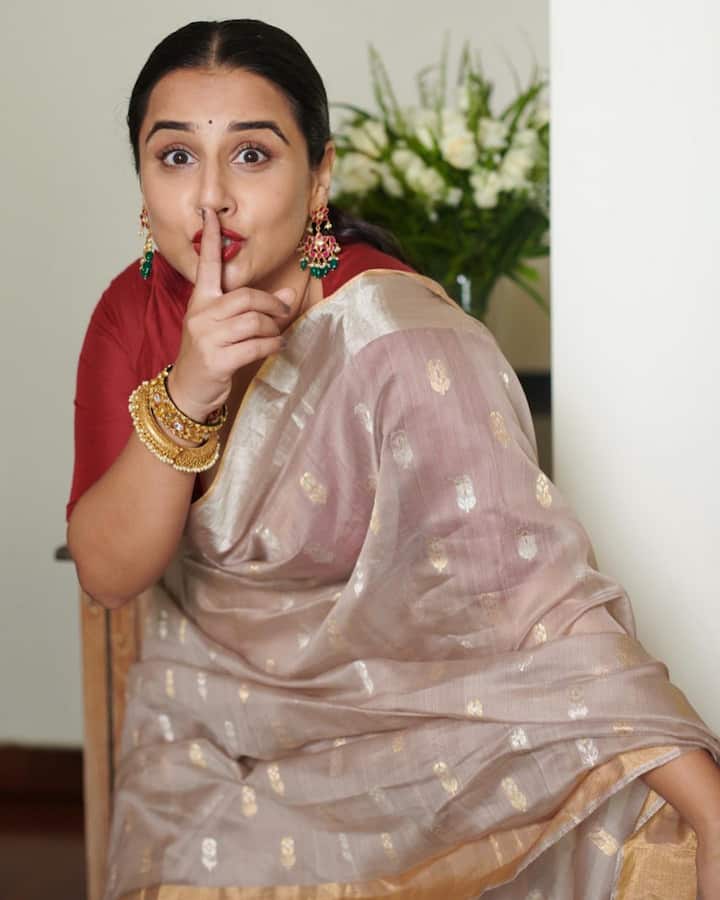 Vidya Balan looked graceful in a soft beige pink saree, paired with a classic deep red blouse.