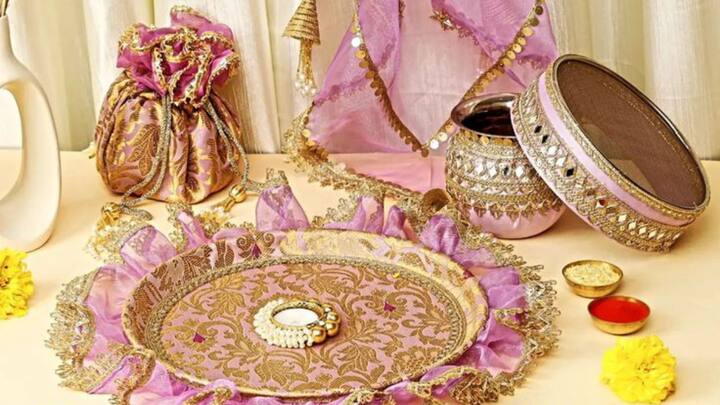 2. Customised Karwa Chauth Thali Set: A personalised Karwa Chauth Thali set is both meaningful and practical. This set, which includes a sieve, an earthen pot (Karwa), and a beautifully crafted plate, with auspicious designs like traditional motifs or mantras will make her puja rituals even more special. (Image source: Pinterest/ Riti Rivaaz)