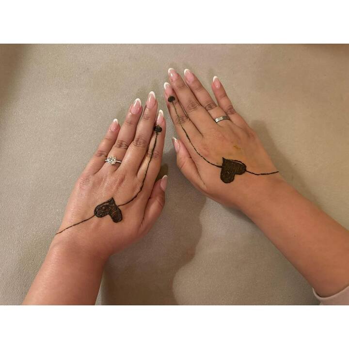 In one of the pictures, Parineeti proudly displayed her minimal mehendi featuring heart design.