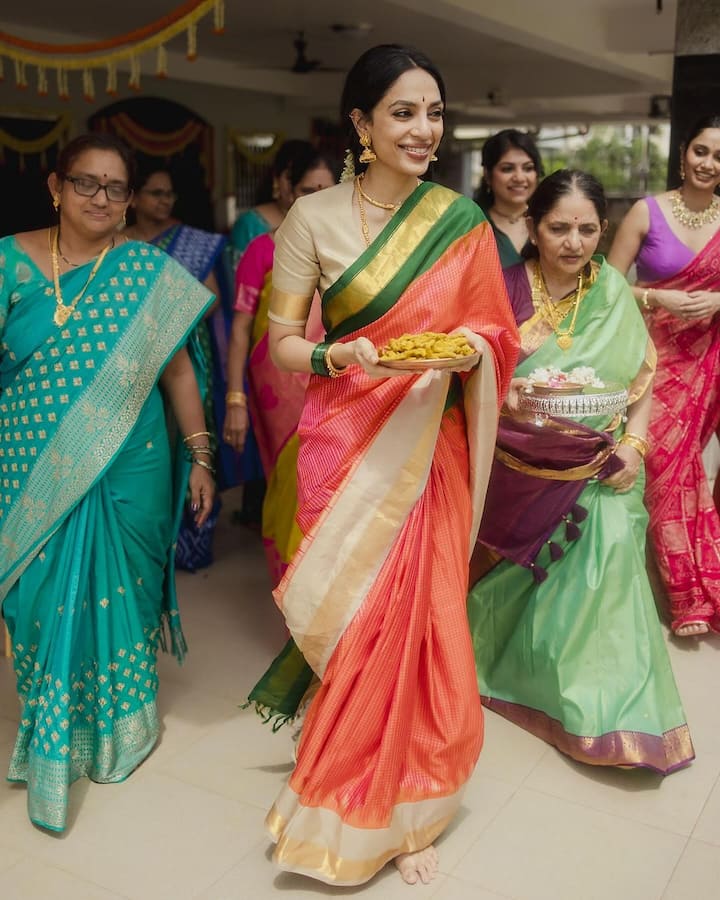 For this wedding ceremony, Shobhita wore an orange colored saree with golden and green border. Which she has paired with a golden blouse.