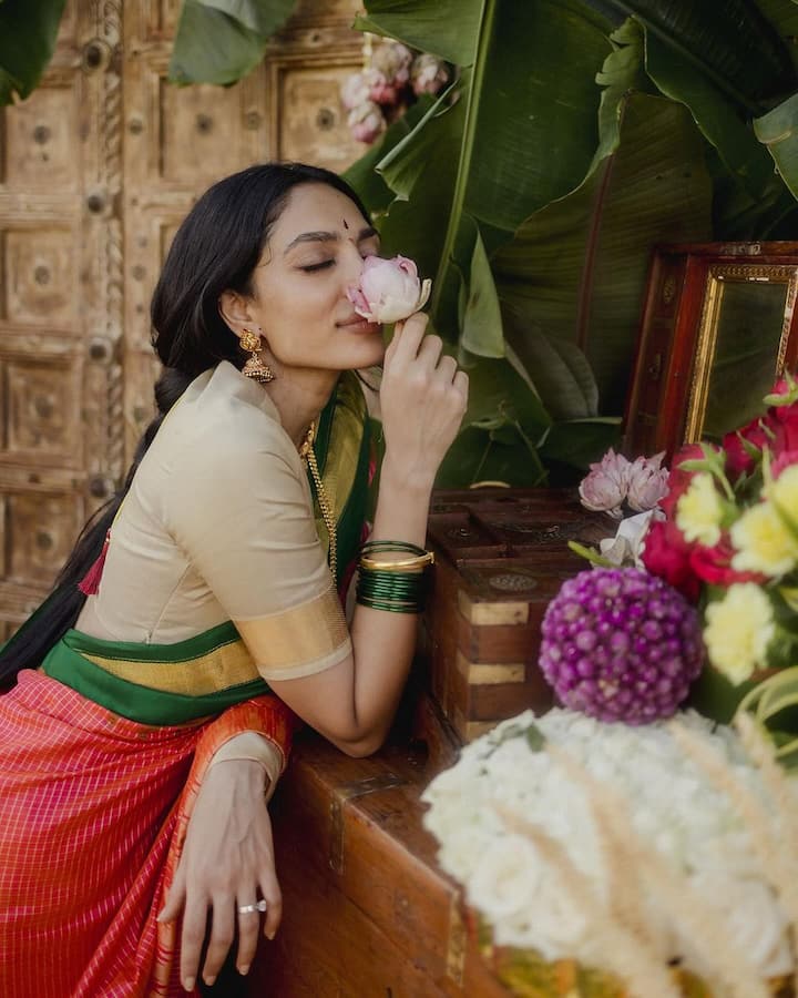 Shobhita has completed her look with gold double layered necklace, earrings and green bangles. Besides, she has also worn Gajra in her hair.