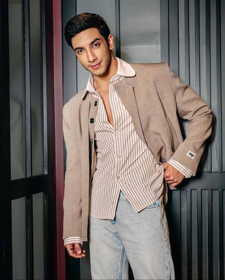 Vedang added a touch of retro to his wardrobe with a beige jacket and striped shirt, paired with light blue denim pants.