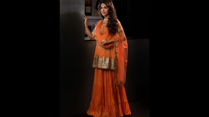 1. Vibrant Orange Sharara Set: Juhi Chawla exudes festive glamour in this bright orange sharara suit. The vibrant colours coupled with delicate detailing creates a perfect balance between tradition and modernity, making it the perfect outfit for Diwali celebrations. (Image Source: Instagram/@iamjuhichawla)