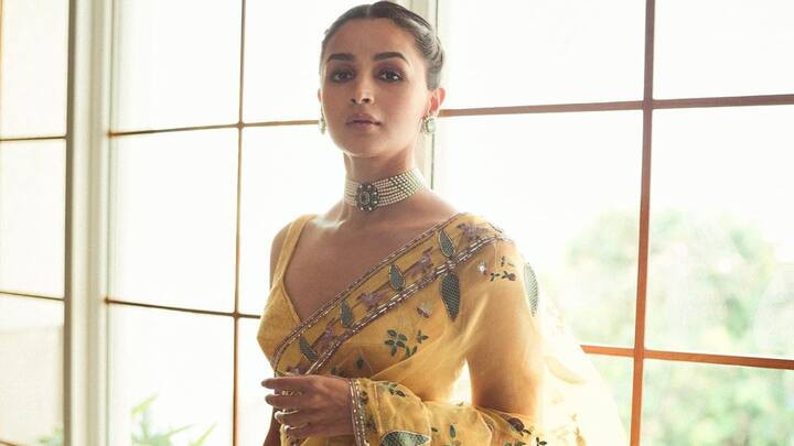 Alia Bhatt: Alia looked radiant in a yellow net saree adorned with floral embroidery, adding a classy, chic vibe to her look. She styled her saree with a sleek bun, nude makeup, and a pearl choker and earrings to balance the elegance. (Image source: Instagram/ aliaabhatt)