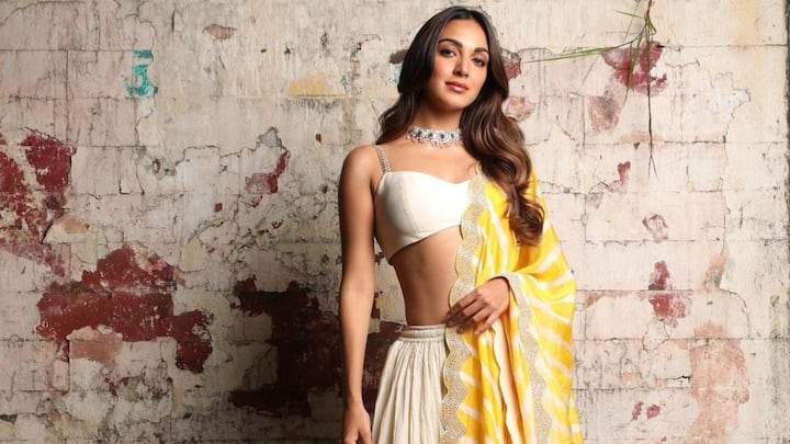Kiara Advani: Kiara's white lehenga paired with a yellow dupatta, blends modernity and tradition for any festive season. Her look, styled with minimal makeup, open hair, and a delicate necklace, was graceful and perfect for festive celebrations. (Image source: Instagram/  kiaraaliaadvani)