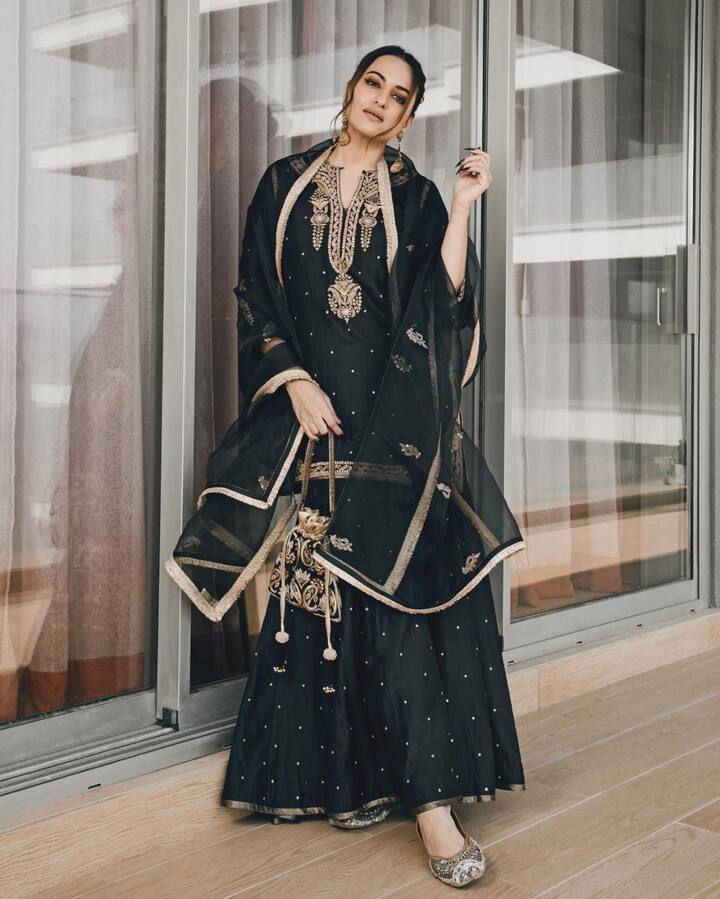Black Sharara: The actress looked stunning in a black sharara set featuring golden motifs. She paired it with dangling earrings and an embroidered black potli bag.