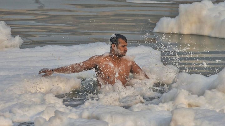 People who migrate to Delhi in search of work and other purposes also celebrate the festival in the national capital alongside the river Yamuna. Image: PTI