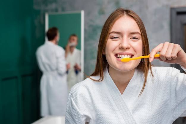 If you are going to brush after eating dinner, then first rinse with water or drink water, this reduces the effect of sour food items and can start the process of strengthening the enamel.