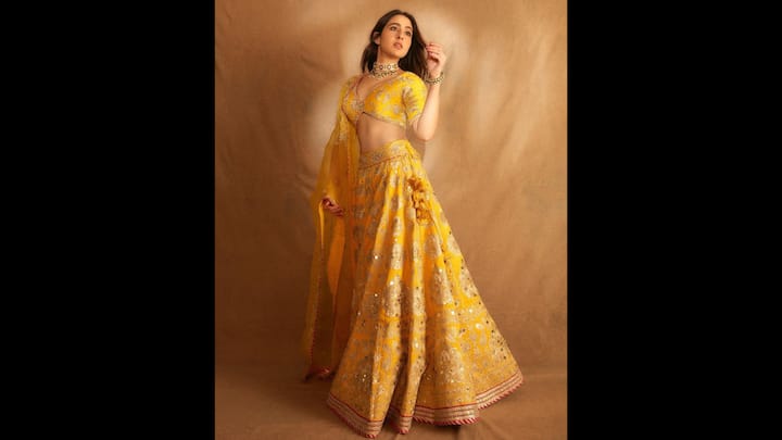 1. Sara Ali Khan: Sara Ali Khan exuded glamour and joy in this vibrant yellow lehenga adorned with gold embroidery. The stunning choli and detailed dupatta created a beautiful festive setting, perfect for a Haldi ceremony that combines the richness of tradition with a youthful touch. (Image Source: Twitter/@filmfare)