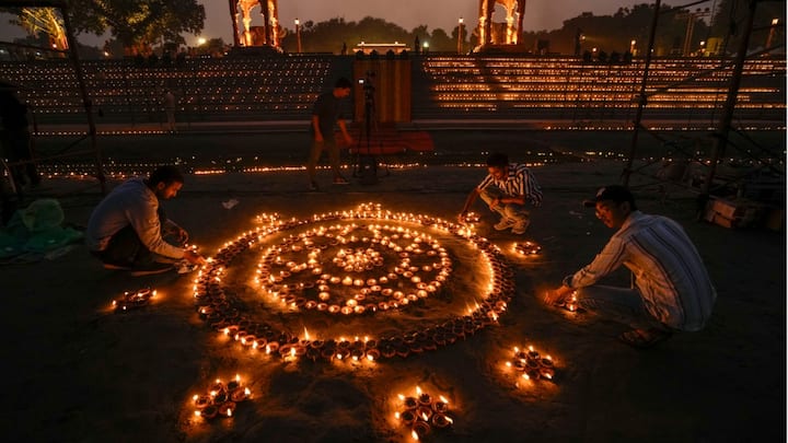 A man lights earthen lamps at Vasudev Ghat on the banks of the Yamuna river as part of 'Dilli Deepotsav'. (Source: PTI)