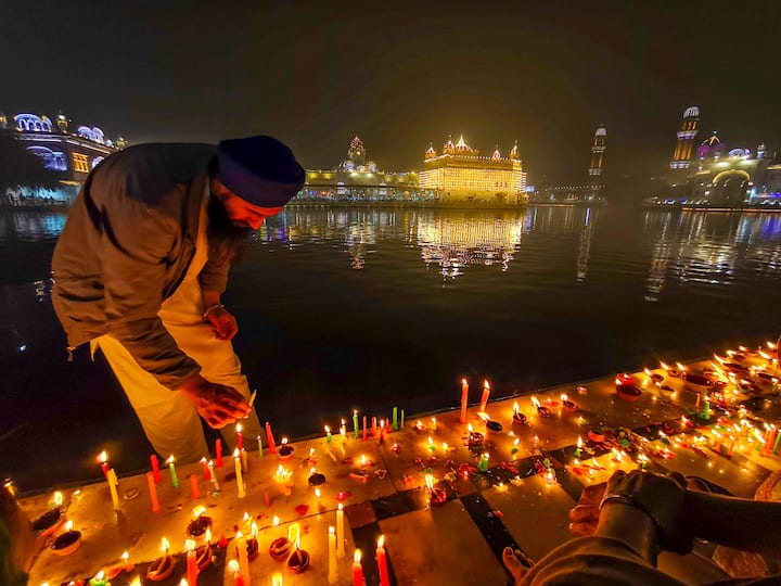 Long queues of people from various faiths were seen at several prominent Sikh shrines, including Sri Harmandir Sahib (Golden Temple) in Amritsar, Sultanpur Lodhi in Kapurthala, and Nada Sahib in Panchkula, Haryana. A devotee lights candles at the Golden Temple on the occasion of Guru Nanak Jayanti, the birth anniversary of the first Sikh guru, in Amritsar, Friday, Nov. 15, 2024. (PTI Photo)