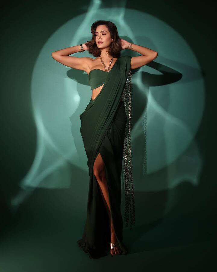 Esha wowed in a fusion dark green saree with a high-waist pleated skirt and a draped pallu over her shoulder.