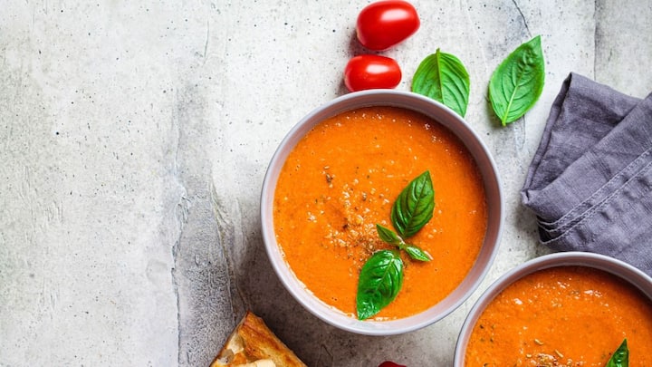 1. Tomato Basil Soup: Tomato and Basil Soup blends ripe tomatoes, fragrant basil, and little cream for a flavourful, tangy, and nutritious dish. It provides the perfect warmth and comfort. (Image Source: Pinterest/herkitchenrecipes)