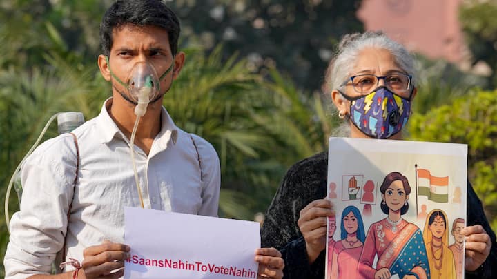 People wearing masks in a protest against air pollution near the Parliament House complex to gather the attention of political leaders. (Photo: PTI)