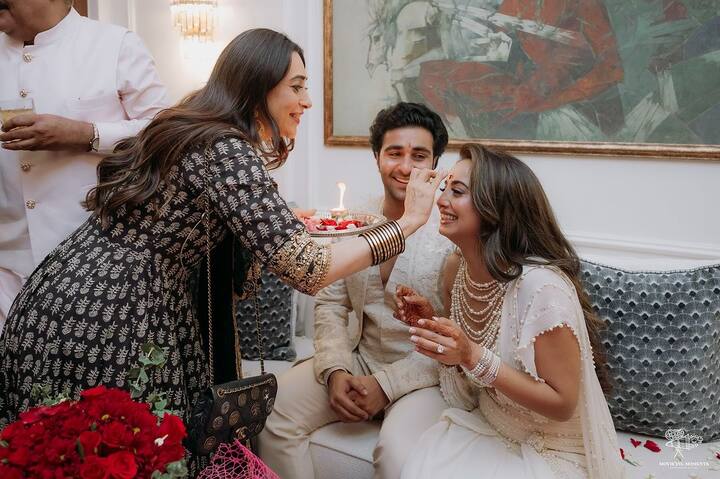 Another photo showed Karisma applying a tika to Alekha.