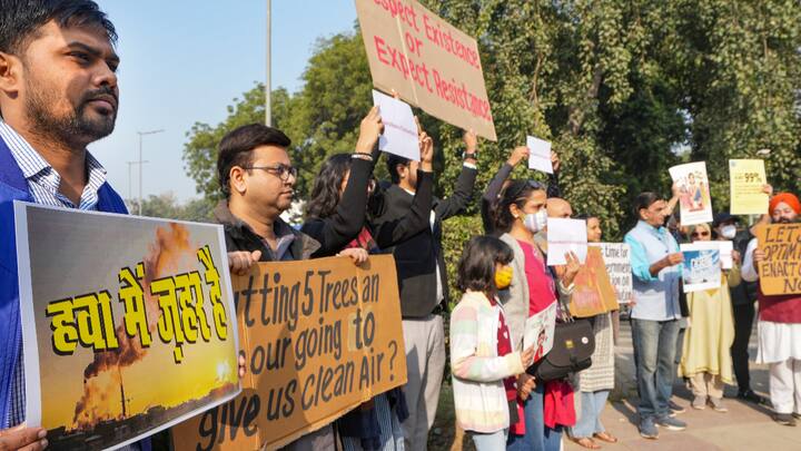 People wearing masks during a protest against air pollution, near the Parliament House complex. The protesters raised placards with messages of 