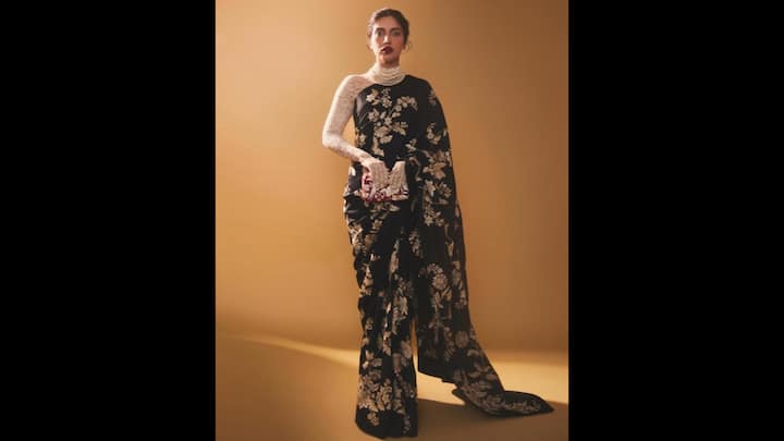 4. Bhumi Pednekar: Bhumi's black saree with golden floral floral work gives her an opulent look. She has paired her outfit with gloves and statement jewellery that enhances her look. This saree is perfect for night or evening events. (Image Source: Instagram/@bhumipednekar)