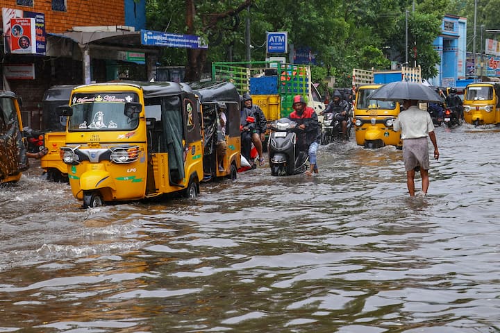 Vehicles move on a waterlogged road amid rain owing to Cyclone Fengal, in Chennai, Saturday, Nov. 30, 2024. (Image Source: PTI)