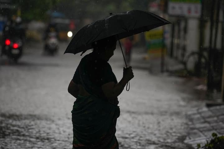 A pedestrian crosses a road amid heavy rain owing to Cyclone Fengal, in Chennai, Saturday, Nov. 30, 2024. (Image Source: PTI)