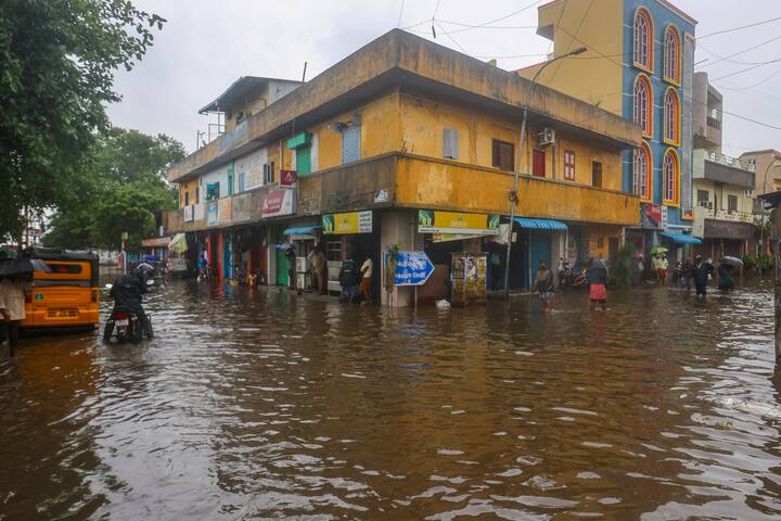 Commuters on a waterlogged road amid rain owing to Cyclone Fengal, in Chennai, Saturday, Nov. 30, 2024. (Image Source: PTI)
