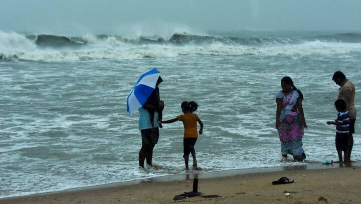 Visitors at a beach at Mamallapuram amid strong winds ahead of the landfall of cyclone Fengal, in Chengalpattu district, Tamil Nadu, Saturday, Nov. 30, 2024. Heavy rains accompanied by gusty winds pounded several parts of northern Tamil Nadu on Saturday, affecting normalcy, as cyclonic storm Fengal, expected to make landfall near Puducherry later in the day, continued moving towards the coast. (Image Source: PTI)