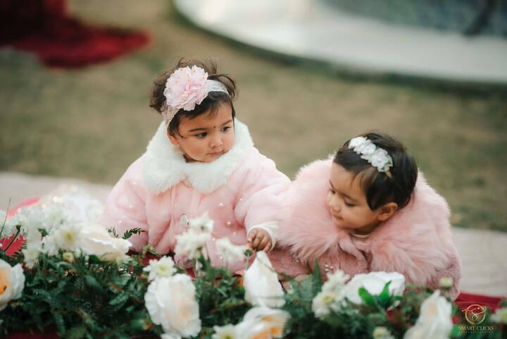 Edhaa and Jeeva were dressed in adorable pink warmers, adding to the cuteness overload.